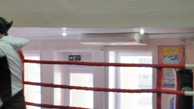 Bir kadın kick boks halka ile bir eğitim savaş eğitmen yürütmektedir