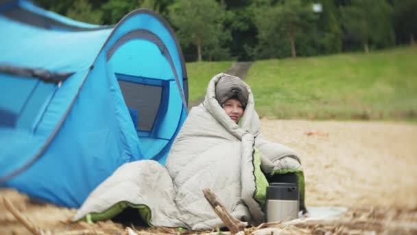 Nehir kıyısında turist çadır. Kız çadır oturur ve nehirde görünüyor. — Stok video