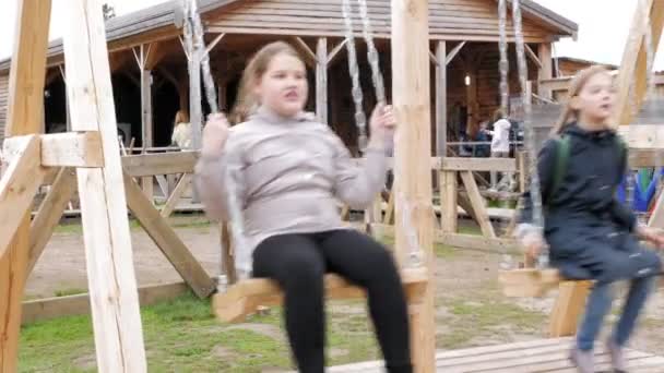 Menina no swing set — Vídeo de Stock