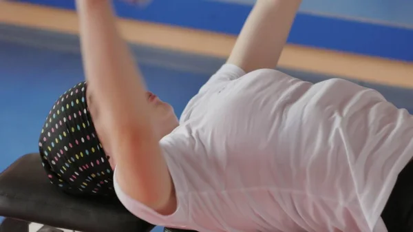 Женщина-кикбоксер тренируется в спортивной студии с гантелями — стоковое фото