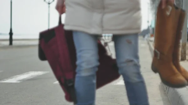 Mooie jongedame in een rode hoed, het dragen van sportieve warme kleren en rollen, rijden op de weg aan de kust — Stockfoto