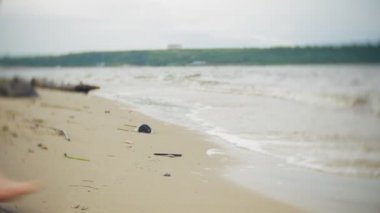 Sahil boyunca seyahat yaşam tarzı macera tatil açık havada yürüyen mutlu kadın. Bir moda sarı yağmurluk giymiş bir kız