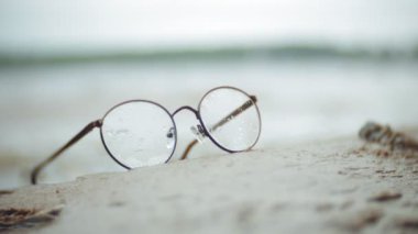 Siyahlısı sahilde dalgaların arka planda puan yuvarlak bir çerçeve içinde yalan