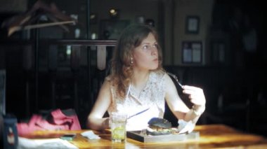 Genç kadın yemek lokanta, siyah hamburger