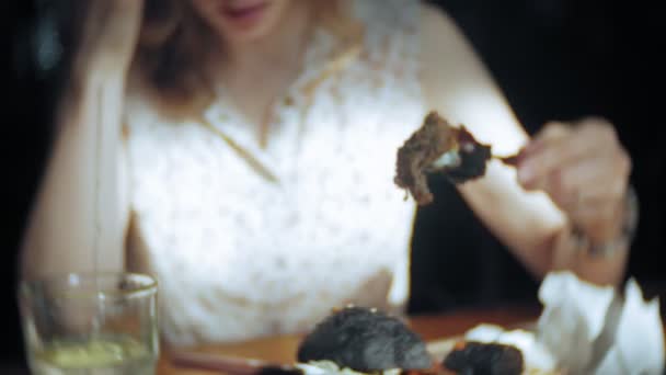 Junge Frau isst Fast Food, schwarzen Hamburger — Stockvideo
