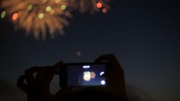 Espectadores con smartphones. Fotografía fuegos artificiales en el teléfono, manos de cerca — Vídeos de Stock