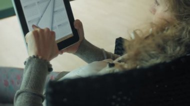 Genç kadın bir tablet bir kafe barda sahiptir