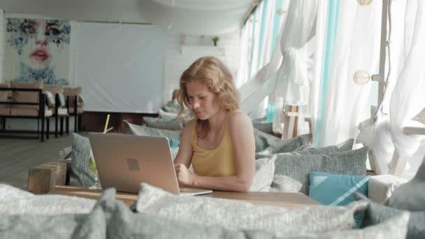 Jeune femme d'affaires boire cocktail mojito assis à table et prendre des notes dans le notebook.On est un ordinateur portable, smartphone. Enseigner aux étudiants en ligne. Blogueur . — Video