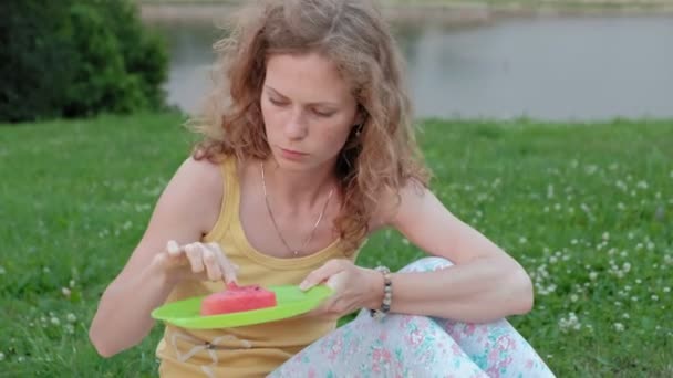 Lycklig familj på en picknick som äter vattenmelon. — Stockvideo
