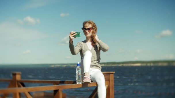 一个女人在海滩上使用智能手机, 从 — 图库视频影像
