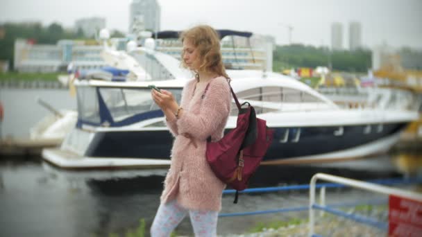 Girl Using Smartphone Seaside Yacht Sailing Harbour — стоковое видео