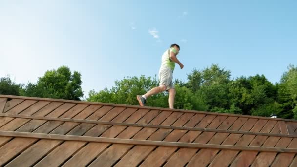 Homme mûr fitness est engagé dans le bek en plein air, dans les écouteurs. Super ralenti — Video