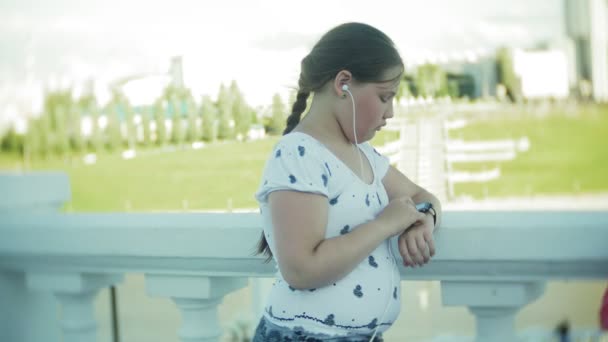 Une grosse fille exécutant un moniteur d'pouls sur une horloge intelligente — Video