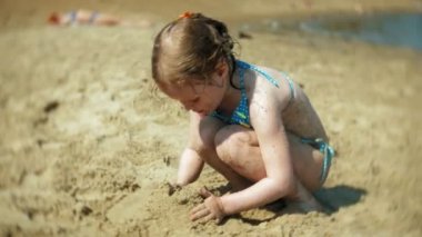 kumlu sahilde oynarken kız bebek