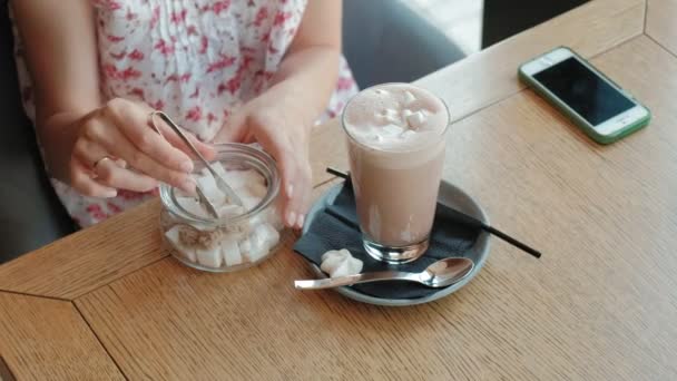 Chica feliz bebiendo café y relajarse en la cafetería, sonriendo y mirando el teléfono inteligente — Vídeos de Stock