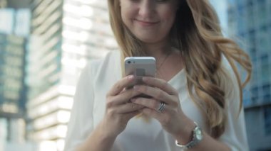 Genç işkadını konuşmak smartphone şehir park iş merkezinde kullanıyor