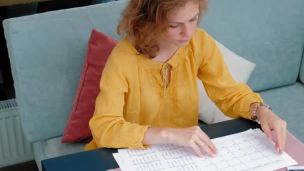 Beautiful young woman browsing documents in a cafe — Stock Video