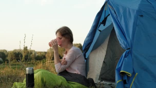 Young woman working behind a laptop in a tourist tent — Stock Video