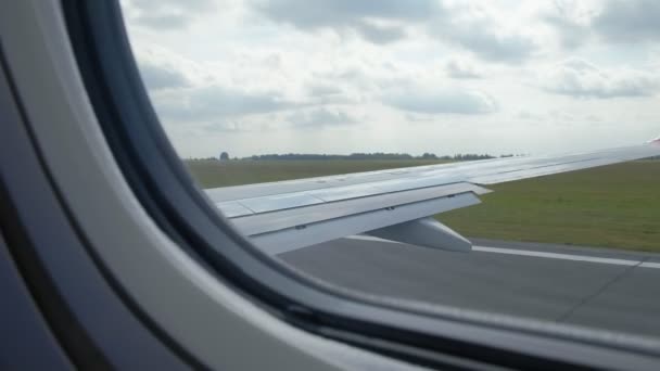 Pohled na modrou oblohu a mraky oknem letadla, úzké okno letadlo s letadlo křídlo, Traveling koncepce. — Stock video