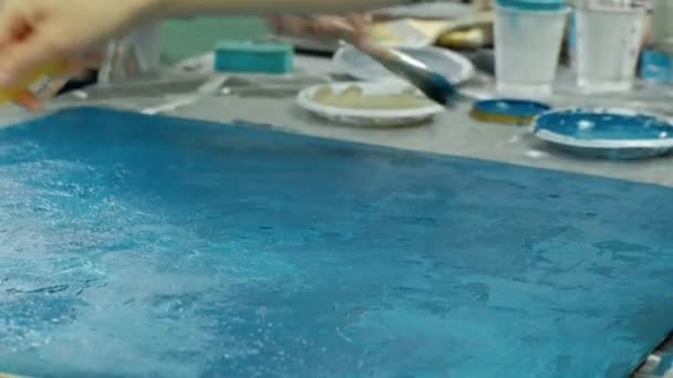 Masters in the art studio process the wood with paint and putty, achieve the aging effect — Stock Video