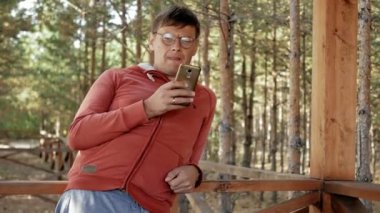 Olgun adam çalışıyor onun laptop üzerinde açık havada doğa onun meslek sırasında büyük tahta masada otururken kontrol e-posta için kendi dizüstü kullanarak forester yaşında.