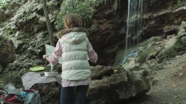 Hikers woman is studying a paper map of the route in the forest — Stock Video