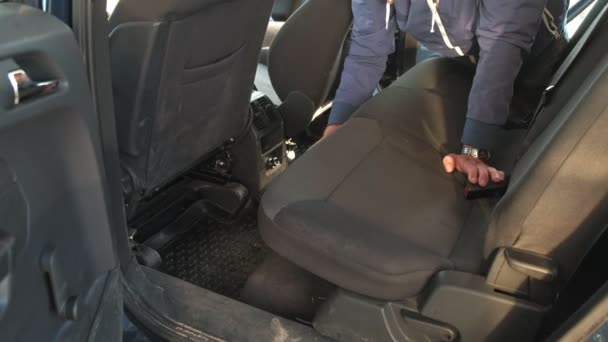 Handyman vacuuming car back seat with vacuum cleaner — Stock Video