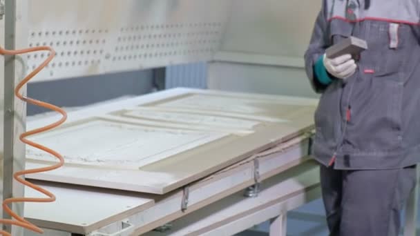 Mujer, el trabajador hace el efecto de puertas envejecidas. producción de puertas interiores de madera — Vídeos de Stock