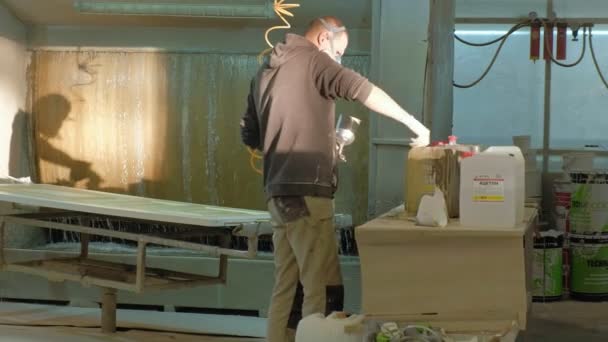 Man, worker paints the door. production of interior doors of wood — Stock Video
