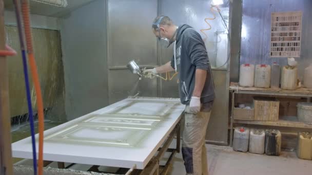 Man, schildert werknemer de deur. Het proces van het maken van houten deuren. productie van binnendeuren van hout — Stockvideo