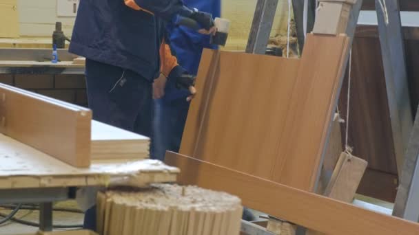 The process of collecting doors from wooden blanks, the production of wooden doors — Stock Video