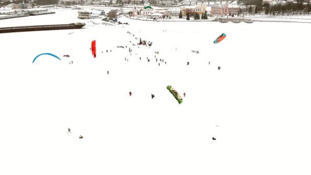 CHEBOKSARY, RUSSIA - DECEMBER 31, 2018: Athletes involved in snowkiting, in the winter ride on the river in the costumes of Santa Claus, aerial photography from a quadrocopter — Stock Video