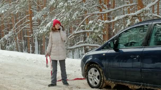 Young Woman Winter Forest Standing Road Broken Car Holding Towing — 图库视频影像