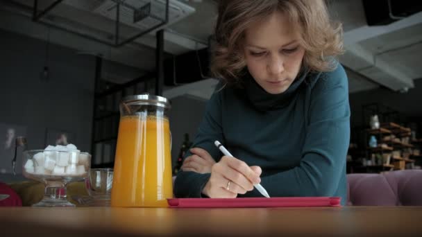 Attractive young woman with tablet in cafe, freelancer concept — Stock Video