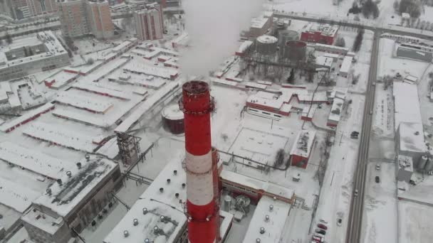 Des nuages de fumée s'élèvent dans le ciel à partir de tuyaux dans le secteur industriel de la ville, une chaufferie municipale. tournage aérien — Video