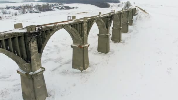 Old railway aqueduct, stone bridge. snow, winter time. aerial, copter shoot — Stock Video