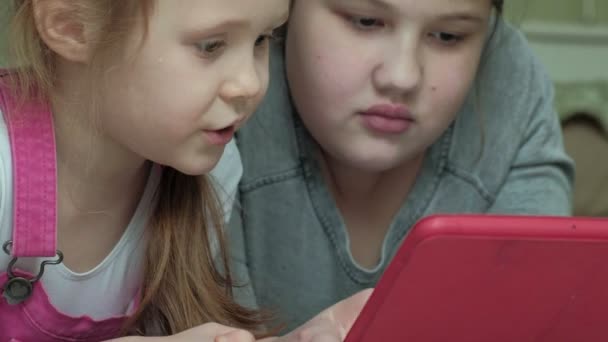 Zusters van de meisjes spelen op de tablet in de kamer, het surfen op het web, de rest — Stockvideo