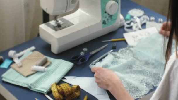 Desktop seamstress, designer lingerie, side view, blue background — Stock Video