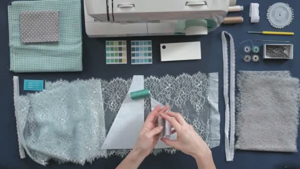 Desktop seamstress, designer lingerie, top view, blue background — Stock Video