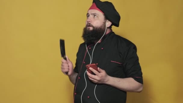 Koka i en svart kostym på gul bakgrund — Stockvideo