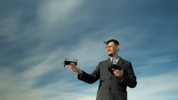Hombre controla quadcopter al aire libre — Vídeos de Stock