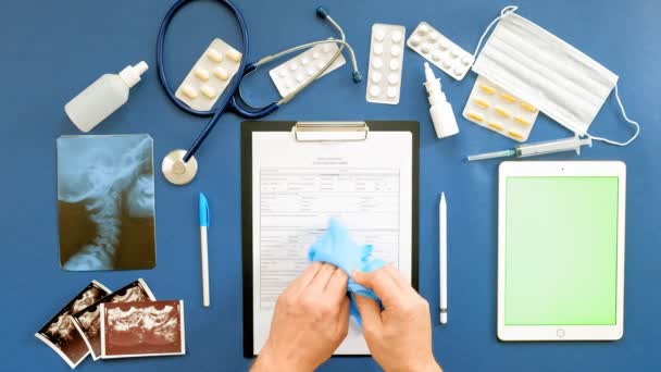 Doctors desk, top view on blue background, medicine concept — Stock Video