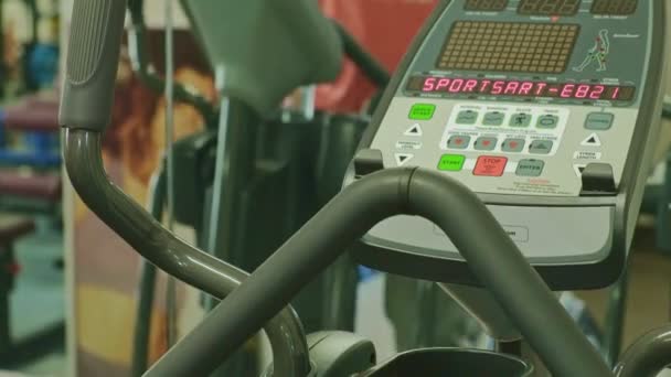 Hombre con máquina elíptica en el gimnasio . — Vídeos de Stock