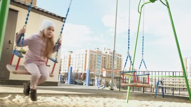Little girl riding on a swing, spring — Stock Video
