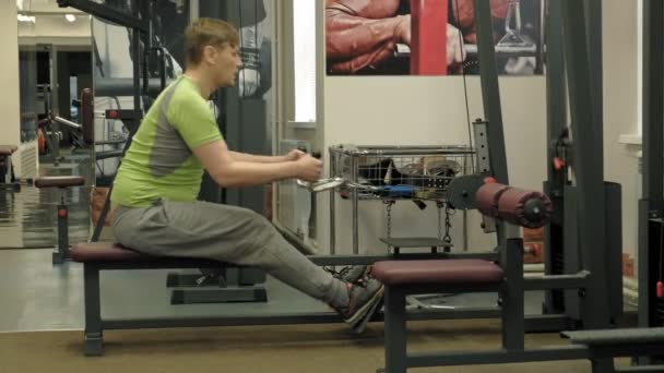 Ο υπέρβαρων άνθρωπος μοιράζεται χαμηλότερες επιθυμίες, ασκήσεις πίσω, στο γυμναστήριο. Γυμναστήριο. Υγιεινός τρόπος ζωής — Αρχείο Βίντεο