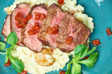 Biftekli beyaz pirinç. Rizzotto. Gri ışıklı arka plan. Güzel yemek servisi.