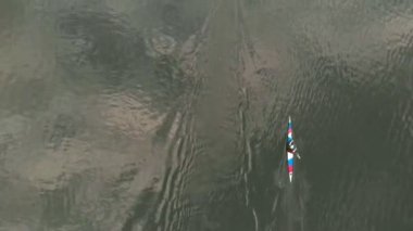 Nehirdeki mavi kanodaki atletler. Sağlıklı yaşam tarzı. Aktif spor. Drone ile hava çekimi.