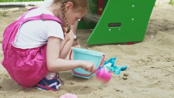 Children use a computer tablet, walk on the playground — Stock Video