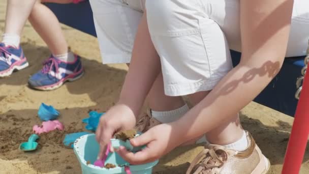 Crianças brincam na caixa de areia ao ar livre — Vídeo de Stock