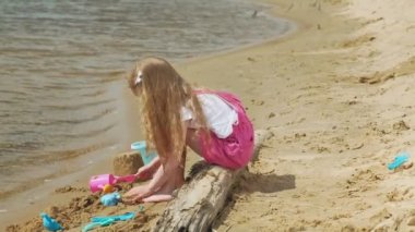 Güneşli bir günde nehir kıyısında ki sahilde oynayan çocuklar